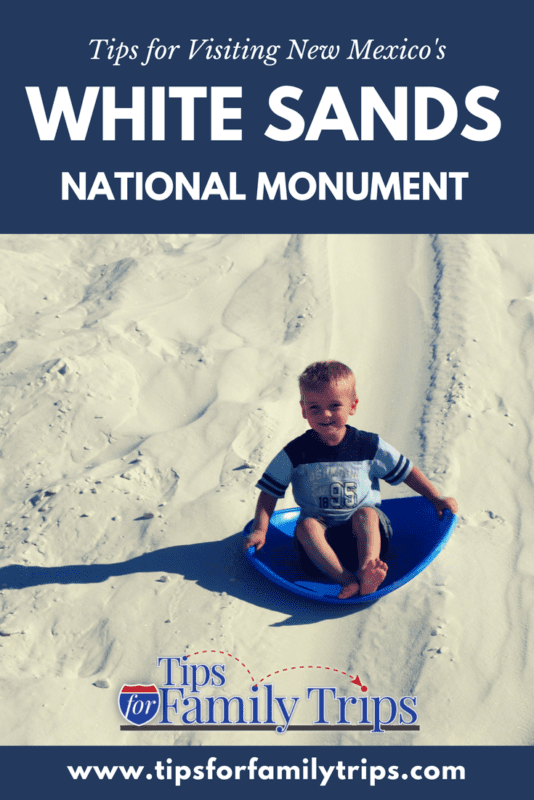 Image with photo and text. Photo of a young boy sledding down a white sand dune at White Sands National Park in New Mexico.
