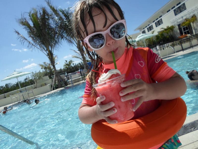 Girl with icy drink at pool at Hutchinson Shores Resort in Florida